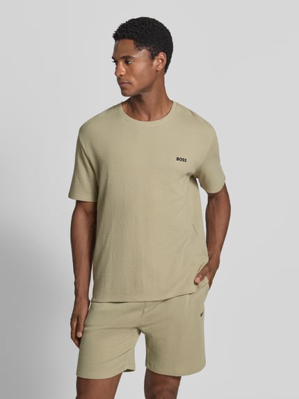 Männermodel trägt Regular Fit T-Shirt aus Baumwoll-Mix von BOSS, unifarben, Waffelstruktur, Rundhals, kurzarm, Ganzkörperansicht von vorne.