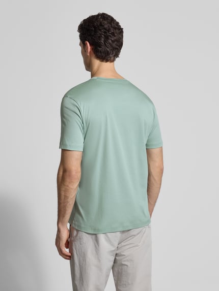 Männermodel trägt Regular Fit T-Shirt aus reiner Baumwolle Modell 'SPIRIT70' von BOSS Green x Porsche in Mintgrün, unifarben, Ganzkörperansicht Rückansicht.
