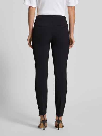 Vrouwenmodel draagt Hose mit Längsnähten Modell 'ROS' van Cambio, zwarte slim fit damessbroek met paspelzakken, volledige achteraanzicht.