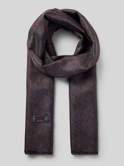 Produktfoto, Wollschal aus reiner Wolle mit Rückseite aus reiner Seide von Ascot, Paisley-Muster, ausgefranste Abschlüsse, Label-Applikation, Breite 33 cm, Länge 158 cm, dunkle Töne mit blauen und roten Akzenten, glatte und weiche Texturen