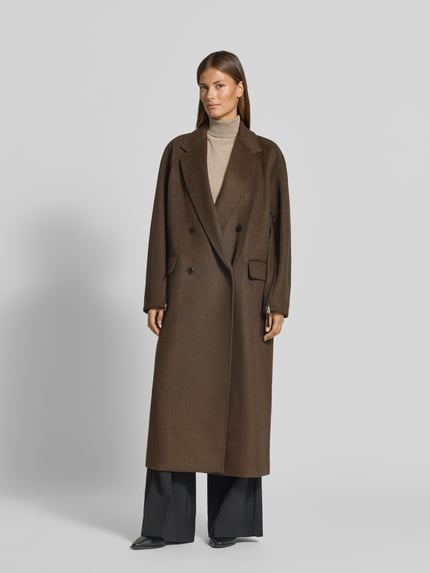 Frauenmodel trägt Relaxed Fit Mantel mit Woll-Anteil Modell 'Malini' von HUGO in Braun, glatte Textur, Damen Mantel, Ganzkörperansicht von vorne.