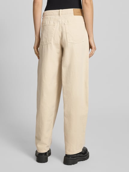 Frauenmodel trägt Wide Fit Jeans im 5-Pocket-Design Modell 'Barrel' von JJXX aus reiner Baumwolle in Beige, Ganzkörperansicht Rückansicht.