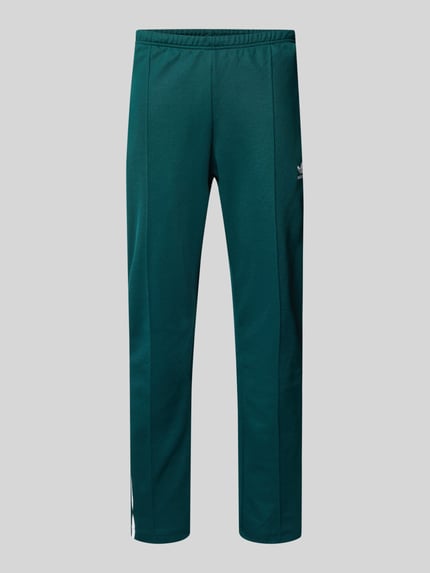 Productfoto, Sweatpants met elastische tailleband van adidas Originals in donkergroen katoenmix, los model, ritszakken, label-stiksel, achterzak.