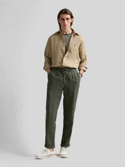 Männermodel trägt Slim Fit Freizeithemd aus reinem Leinen von Polo Ralph Lauren, beige, unifarben, Knopfleiste, Ganzkörperansicht von vorne.