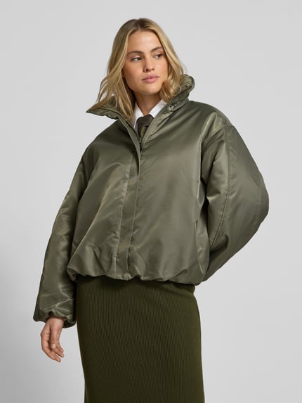 Frauenmodel trägt Bomberjacke mit Stehkragen Modell 'CYRUS' von Anine Bing, unifarben, cropped, reine Baumwolle, Ganzkörperansicht von vorne.