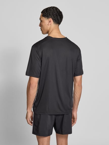 Männermodel trägt Regular Fit T-Shirt mit Logo-Print von adidas Training, Optik: Unifarben, schnelltrocknend, Ganzkörperansicht Rückansicht.
