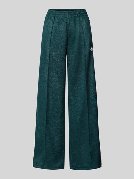 Produktfoto, Sweatpants met elastische tailleband van adidas Originals, losvallende pasvorm, glittereffect, label-stiksel, ritszakken, donkergroene kleur, zachte textuur