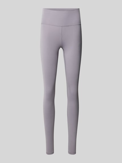 Produktfoto, schlanke Slim Fit Leggings mit Logo-Print Modell 'Harmony' von New Balance in Hellgrau, glatte Jersey-Oberfläche, elastischer Bund.