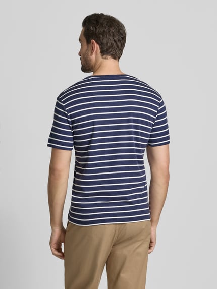 Męski model nosi T-Shirt mit Label-Stitching od Polo Ralph Lauren, bawełna, regular fit, granatowe paski, widok całej sylwetki z tyłu.