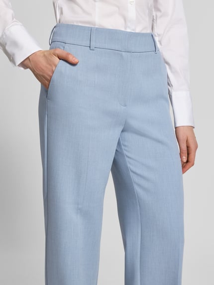 Männermodel trägt Regular Fit Weite Hose mit Viskose-Anteil Modell 'RITA' von Selected Femme, jasnoniebieska melange, kieszeń boczna, materiał: tkanina, krój regular fit, szczegóły: szlufki, zapięcie na haczyk i ukryty zamek, krótki opis, damska, Szerokość w rozmiarze, z boku, zbliżenie na górną część
