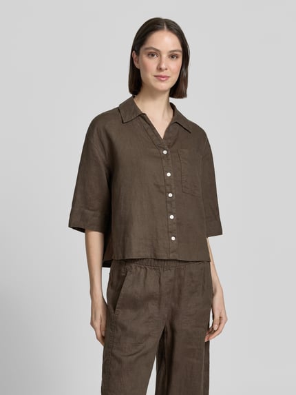 Frauenmodel trägt Regular Fit Leinenbluse mit Brusttasche Modell 'Flippa' von OPUS in Braun, reine Leinen, Hemdblusenkragen, V-Ausschnitt, Ganzkörperansicht von vorne