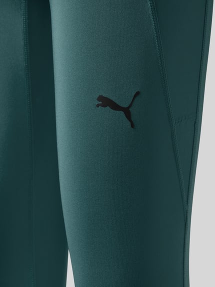 Produktfoto, türkise Skinny Fit Sport-Leggings mit Logo-Print von PUMA Performance, glatte Struktur, dezente Nähte