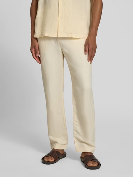 Męski model nosi Straight Leg Stoffhose aus Leinen-Mix von Lacoste, jednokolorowy, mieszanka lnu, wpuszczane kieszenie, naszywka z logo, zapięcie na guzik i zamek błyskawiczny, elastyczny ściągacz z regulacją szerokości, cieniowana przędza, widok całej sylwetki od przodu.
