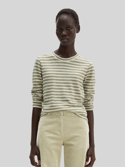 Vrouwenmodel draagt Regular Fit Langarmshirt uit pure katoen van Marc O'Polo in lichtgroen en wit gestreept, neutrale achtergrond, close-up bovenlichaam.