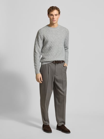 Męski model nosi Strickpullover mit gerippten Abschlüssen Modell 'BLASIMON' od Jack & Jones Premium, szary, regular fit, zbliżenie całości od przodu.