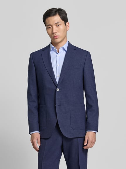 Männermodel trägt Regular Fit Anzugsakko mit Woll-Anteil Modell 'JANSON' von BOSS in Melange-Optik, Twill, Ganzkörperansicht von vorne.