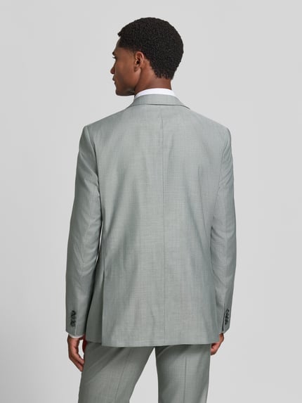 Mannenmodel draagt Slim Fit pak uit scheerwolmix met viscose van ROY ROBSON, lichtgrijs met fijne structuur, volledig beeld van achteren. Context: Heren pak van ROY ROBSON, elastische scheerwolmix met viscose, slim fit, reverskraag, borst- en klepzakken, 2-knoopsluiting, broek met haakjes- en ritssluiting, persplooien, steek- en achterzakken, bandwijdte maat 50: 45 cm, ruglengte maat 50: 73 cm, schouderbreedte maat 50: 40 cm, mouwlengte maat 50: 63 cm, binnenbeenlengte maat 50: 85 cm