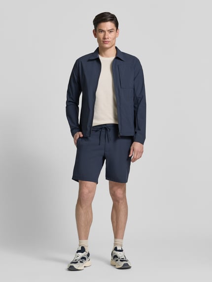 Mannenmodel draagt Regular fit jacke met omlegkraag Modell 'Motion' van SCANDINAVIAN EDITION in donkerblauw, elastische materiaalmix, Napoleonzak, tweerichtingsrits, steekzakken, lengte rug 73 cm, schouderbreedte 45 cm, borstwijdte 50 cm, mouwlengte 66 cm, kleur effen, gladde textuur. Volledig lichaamsaanzicht van voren.