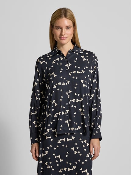 Frauenmodel trägt Oversized Langarmbluse aus reiner Viskose von Marc O'Polo in Dunkelblau mit floralem Allover-Muster, Ganzkörperansicht von vorne.