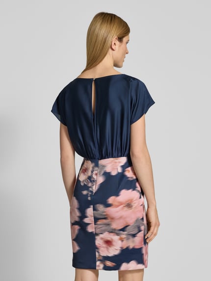 Vrouwenmodel draagt Knielanges Cocktailkleid met Knotendetail van SWING in materiaalmix met stretch, recht model, knielengte, ruglengte maat 36 92 cm, borstwijdte 41 cm, mouwlengte 13 cm, blauw met roze bloemen, detailopname rugaanzicht