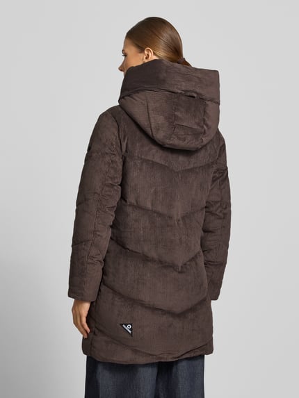 Frauenmodel trägt Jacke aus Cord mit Zweiwege-Reißverschluss Modell 'KATTIE' von khujo in Braun, strukturierte Oberfläche, Ganzkörperansicht Rückansicht. Damenjacke im Regular Fit, Material-Mix mit Stretch, sichtbare Kapuze und Reißverschlusstaschen.
