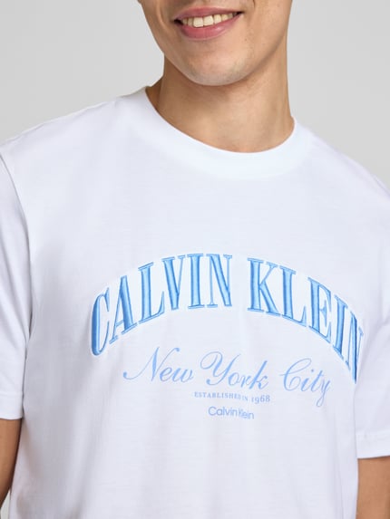 Männermodel trägt T-Shirt mit Label-Stitching von Calvin Klein Jeans aus Reine Baumwolle in Weiß, Slim-Fit, Rundhalsausschnitt, Nahaufnahme Oberkörper