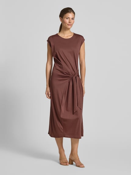 Vrouwenmodel draagt Midikleid in Wickel-Optik van Rinascimento in bruin, katoen-modal-mix, getailleerde fit, ronde hals, korte mouwen, volledige lichaamsvoorzijde.