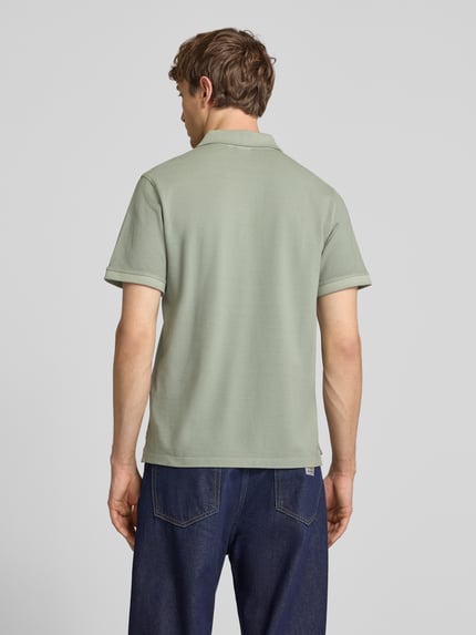 Männermodel trägt Regular Fit Poloshirt aus reiner Baumwolle Modell 'OSCAR' von Pepe Jeans, Optik: Unifarben, Ganzkörperansicht Rückansicht.