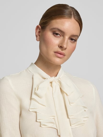 Vrouwenmodel draagt Regular Fit Schluppenbluse met Rüschen van Christian Berg Woman Selection, ivoorkleur, fijne textuur, knoopsluiting, lange mouw, detailopname bovenlichaam