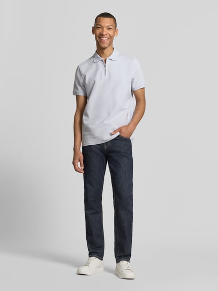 Männermodel trägt Regular Fit Poloshirt mit Strukturmuster von MCNEAL, Reißverschluss, kurzärmelig, helle Farbe, Ganzkörperansicht von vorne.