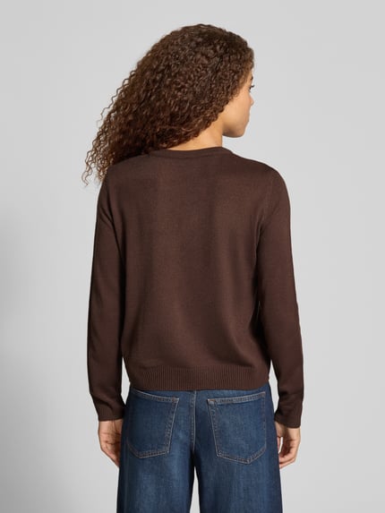 Frauenmodel trägt Rollkragenpullover mit weihnachtlichem Motiv-Print von ONLY, mehrfarbig, Strickoptik, Ganzkörperansicht Rückansicht.