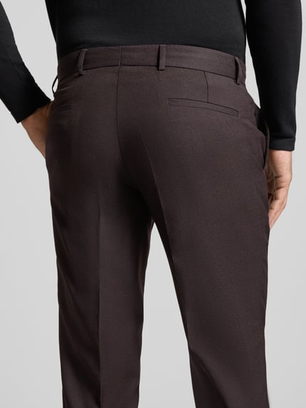 Männermodel draagt straight fit Heren pantalon van zuivere scheerwol Model 'Paco' van CG – CLUB of GENTS in donkerbruin, Bandplooien, knoop- en ritssluiting, zijzakken en achterzakken, Ganzkörperansicht Rückansicht
