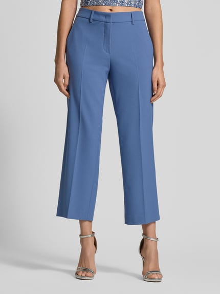 Frauenmodel trägt Wide Fit Stoffhose mit Viskose-Anteil Modell 'Olessa' von Raffaello Rossi in Blau, sichtbare Bügelfalten, Nahaufnahme Unterkörper, elastischer Material-Mix, Haken- und Reißverschluss.