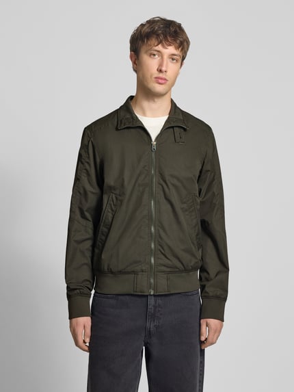 Männermodel trägt Jacke mit Stehkragen und Reißverschluss von G-Star Raw in Dunkelgrün, Baumwoll-Mix, Regular Fit, Ganzkörperansicht von vorne. Rückenlänge 67 cm, Schulterbreite 48 cm, Brustweite 55 cm, Ärmellänge 70 cm.