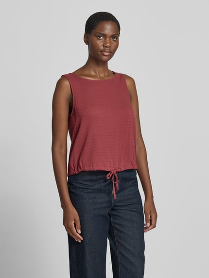 Frauenmodel trägt Regular Fit Blusentop aus Viskose-Mix von s.Oliver RED LABEL in Dunkelrot mit feiner Struktur, Ganzkörperansicht von vorne.