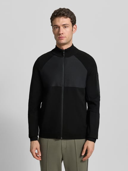 Mannenmodel draagt Regular Fit Sweatjack uit viscosemix Model 'TOUR HY' van BOSS Green, effen zwarte kleur, jacquard, ritssluiting, opstaande kraag, labelpatch, lange mouwen met geribde boorden, zijsteekzakken. Ganzkörperansicht van voren.