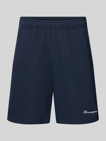 Produktfoto, Shorts mit elastischem Bund und Label-Stitching von CHAMPION, bawełniana tkanina, krój regular fit, szerokość w rozmiarze M 43 cm, długość wewnętrzna nogawki 17 cm, granatowy kolor, gładka tekstura