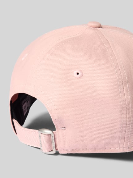Produktfoto, Basecap aus reiner Baumwolle von New Era w kolorze jasnoróżowym z daszkiem, pikowaniem, aplikacje z motywem i regulowanym paskiem z tyłu