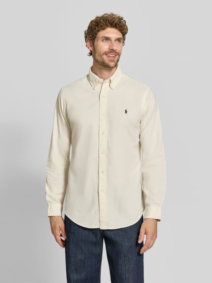 Männermodel trägt Custom Fit Freizeithemd aus reiner Baumwolle von Polo Ralph Lauren in Creme, strukturierter Stoff, Ganzkörperansicht von vorne.