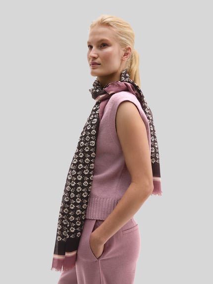 Frauenmodel trägt Schal mit großem Logo-Print von MARC O'POLO, mehrfarbig mit abstraktem, grafischem Allover-Muster, Webware, Ganzkörperansicht von vorne.