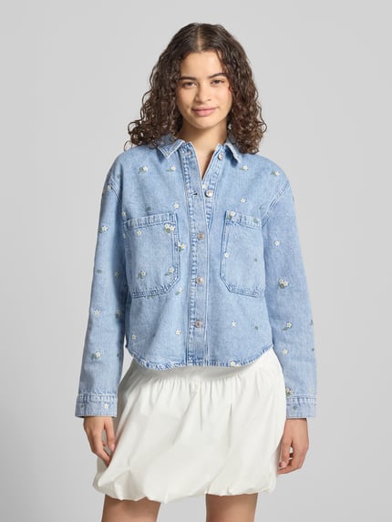 Frauenmodel trägt Regular-Fit Jeansjacke aus reiner Baumwolle Modell 'CASSIE' von ONLY, helle Waschung, Dekor mit kleinen Stickereien, Damen, Ganzkörperansicht von vorne.