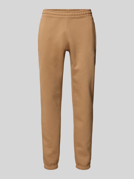 Produktfoto, Sweatpants mit elastischem Bund od adidas Originals w kolorze beżowym, bawełniany miks, luźny krój, elastyczny pas, kieszenie.