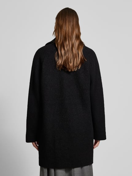 Frauenmodel trägt Wollmantel mit Reverskragen Modell 'CALODINO2' von BOSS, unifarben, Comfort Fit, reine Wolle, Ganzkörperansicht Rückansicht.