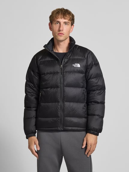 Männermodel trägt schwarze Steppjacke mit Label-Stitching Modell 'HYDRENALITE DOWN JACKET' von The North Face, Ganzkörperansicht von vorne. Regular Fit, Stehkragen, Reißverschluss und Reißverschlusstaschen, glatte Textur.