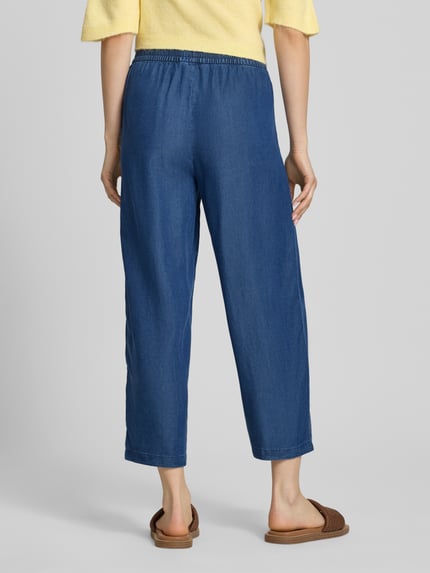 Frauenmodel trägt Relaxed Fit Culotte aus reinem Lyocell Modell 'CHARIS' von Only in Denim-Optik mit Elastisch-Bundabschluss, Popeline-Materialverarbeitung und seitlichen Eingrifftaschen, Material Lyocell, Ganzkörperansicht Rückansicht.