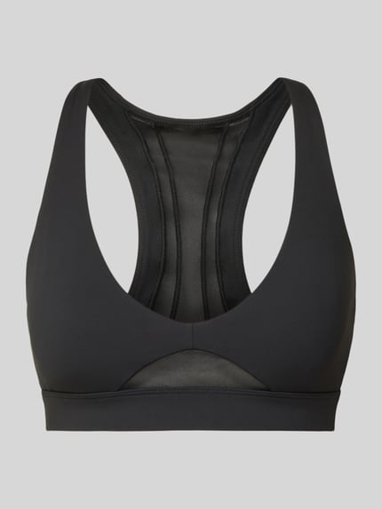 Produktfoto, schwarzer Sport BH mit semitransparenten Partien Modell 'Pureluxe' von Fabletics, elastischer Mix, eng anliegend.