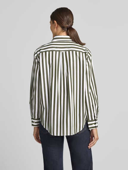 Frauenmodel trägt Relaxed Fit Langarmbluse aus reiner Baumwolle in Weiß mit grünen Streifen von GANT, Damen Langarmbluse, Ganzkörperansicht Rückansicht.