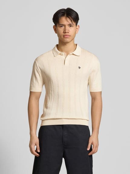 Männermodel trägt Slim Fit Strick-Poloshirt mit Label-Stitching von REVIEW, Zopfmuster, Reine Baumwolle, Knopfleiste, Ganzkörperansicht von vorne.