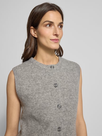 Kobiece modelka nosi Strickweste mit Rundhalsausschnitt und Knopfleiste od Oui, szary melanż, faktura dzianiny, regular fit, zbliżenie górnej części ciała.
