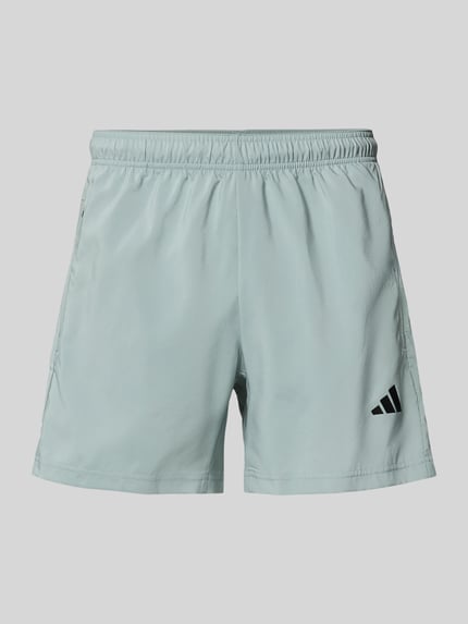Produktfoto, Shorts mit elastischem Bund von adidas Training, prosty krój, nadruk z logo, kieszenie zapinane na zamek błyskawiczny, szerokość w rozmiarze M: 39 cm, długość wewnętrzna nogawki w rozmiarze M: 14 cm, jasnoniebieski, gładka tekstura